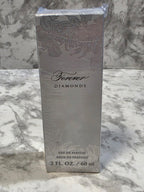 Perfume bottle packaging with floral design and brand name on a marble background