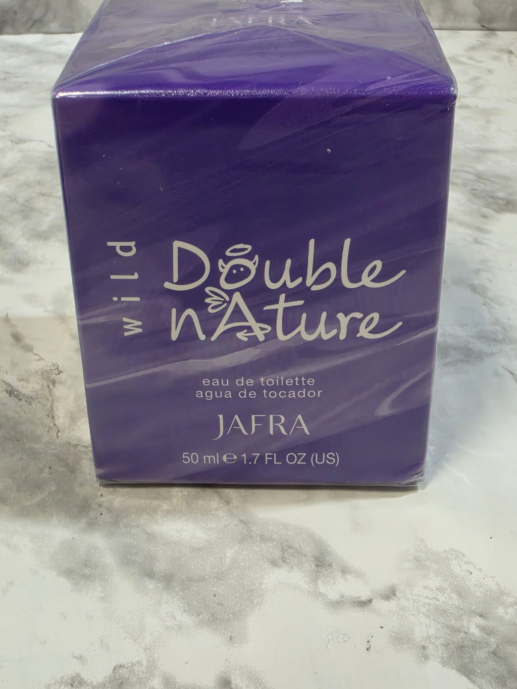 Purple perfume box labeled 'Double Nature' by AFRA on a marble surface