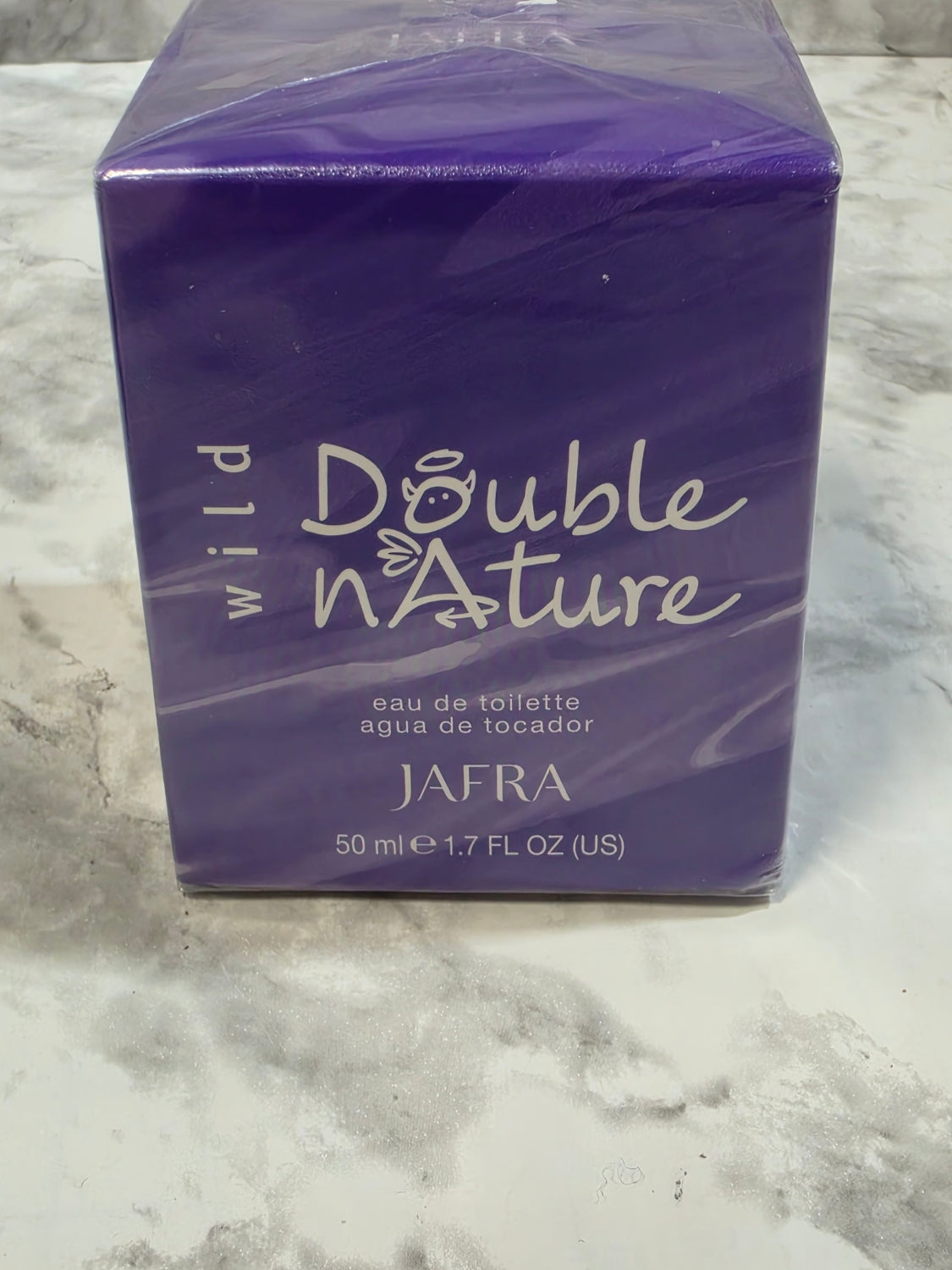 Purple perfume box labeled 'Double Nature' by AFRA on a marble surface