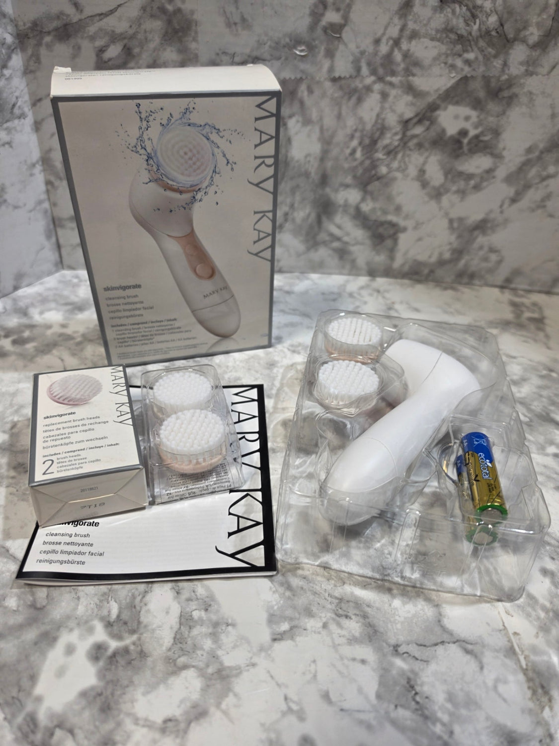 Mary Kay facial cleansing brush set with packaging on a marble surface