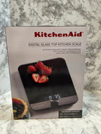 KitchenAid digital glass top kitchen scale packaging on a marble countertop