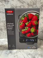 OXO food scale with strawberries on a marble surface