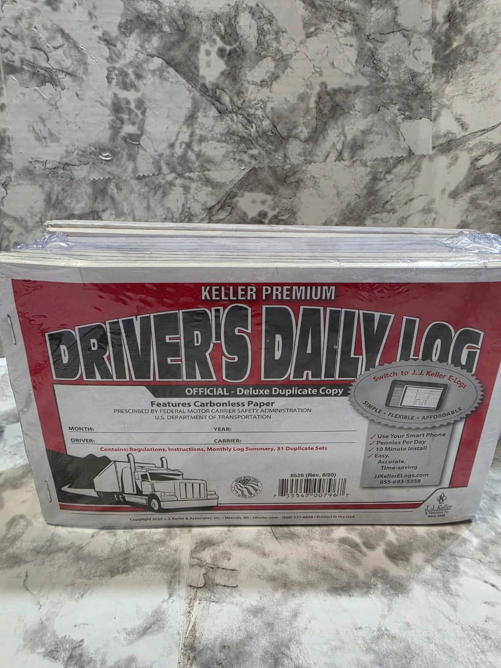 Kelter Premium Drivers Daily Log book on a marble surface