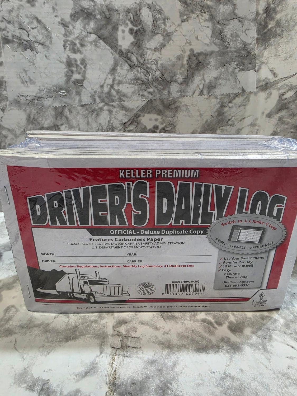 Kelter Premium Drivers Daily Log book on a marble surface