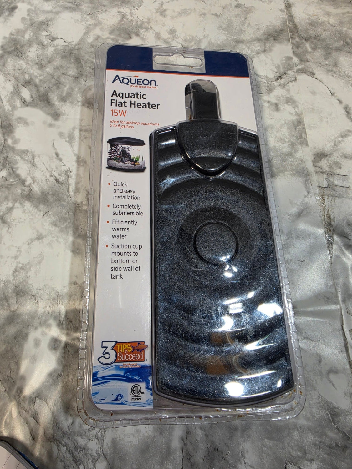 Aquascape aquarium heater on a marble surface