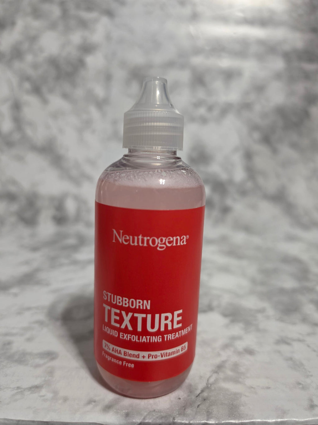 Neutrogena bottle on a gray textured background