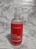 Neutrogena bottle on a gray textured background