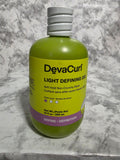Devacurl Light Defining Gel bottle on a marble surface