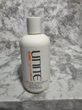 Unite Boing Curl Conditioner bottle on a marble surface