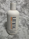 Unite Boing Curl Shampoo bottle on a marble surface