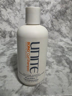 Unite Boing Curl Shampoo bottle on a marble surface