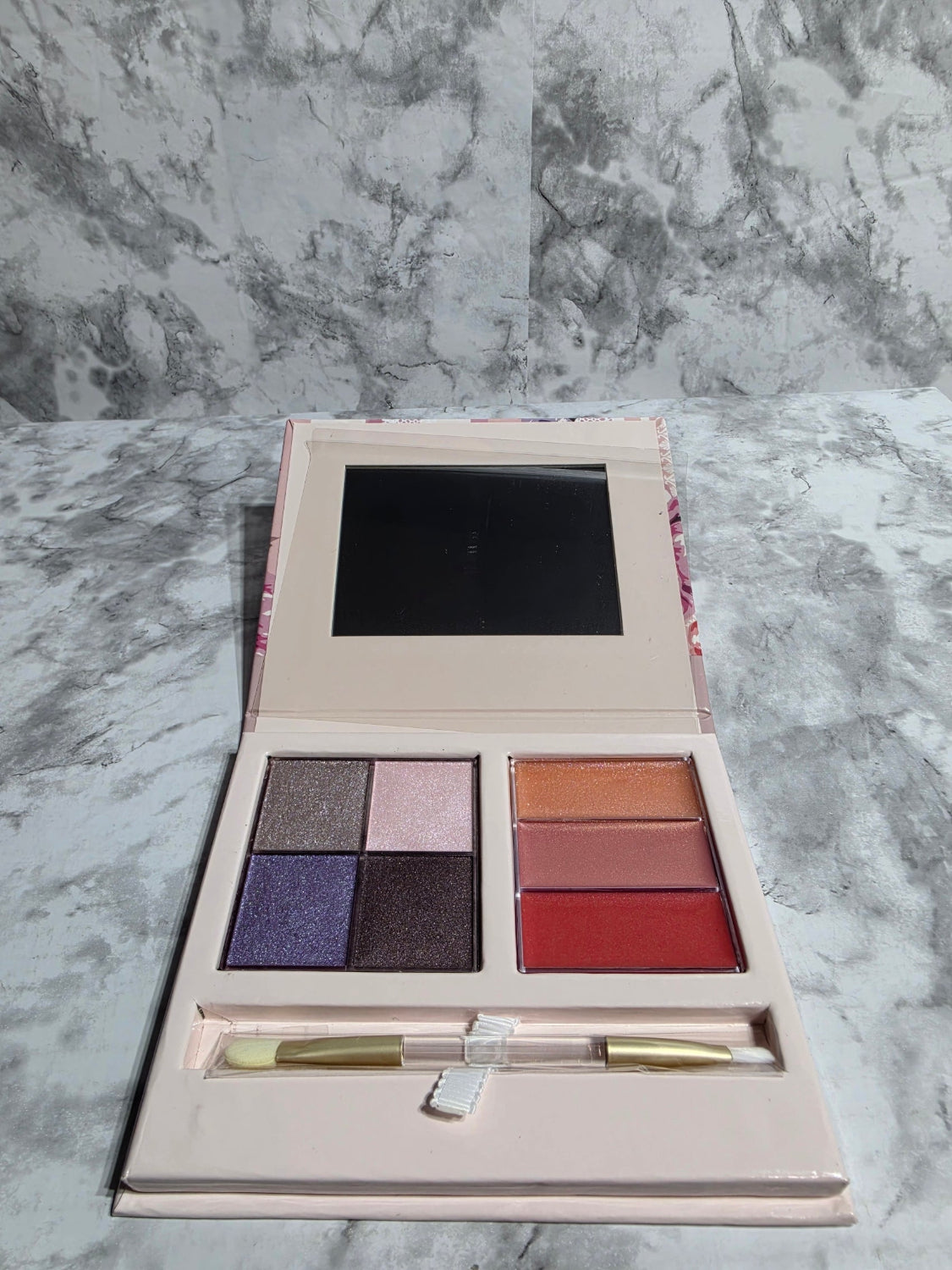 Makeup palette with eyeshadows on a marble background