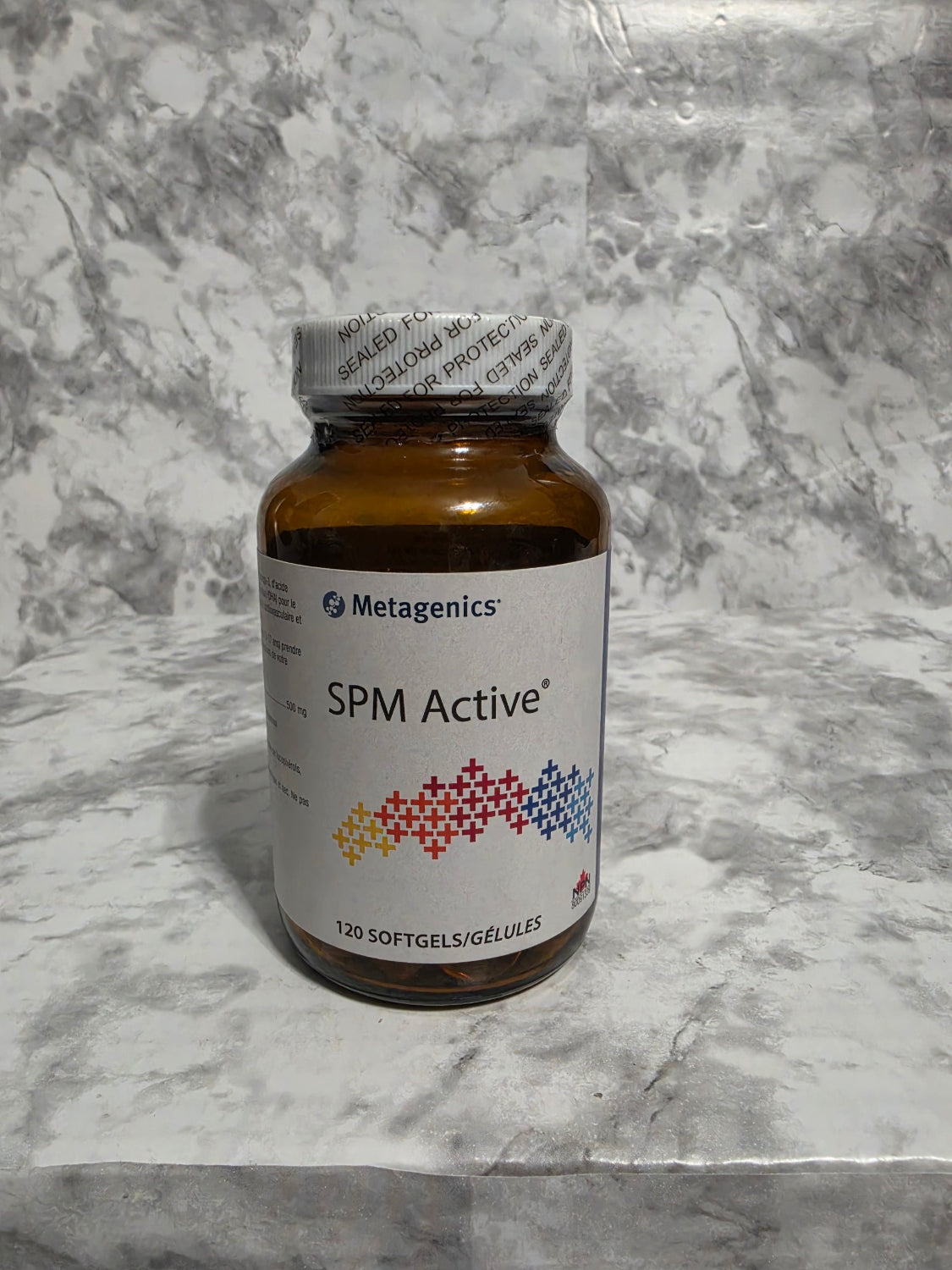 Bottle of SPME Active supplement on a marble surface