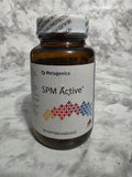 Bottle of SPM Active supplement with Metagenics label on a marble surface