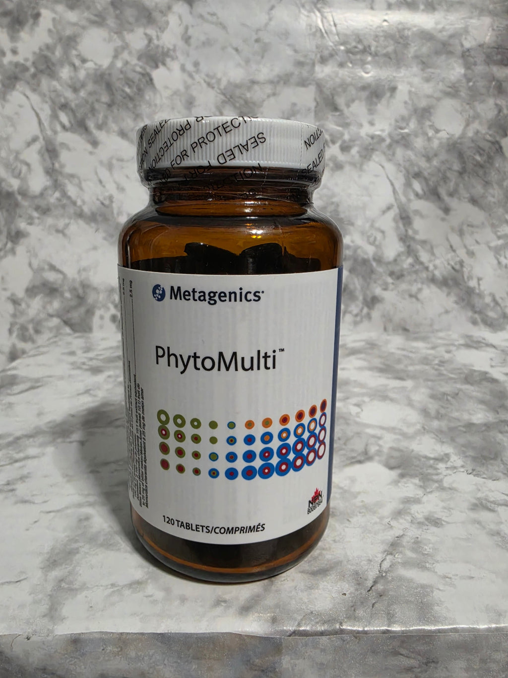 Metagenics PhytoMulti supplement bottle on a gray marble surface