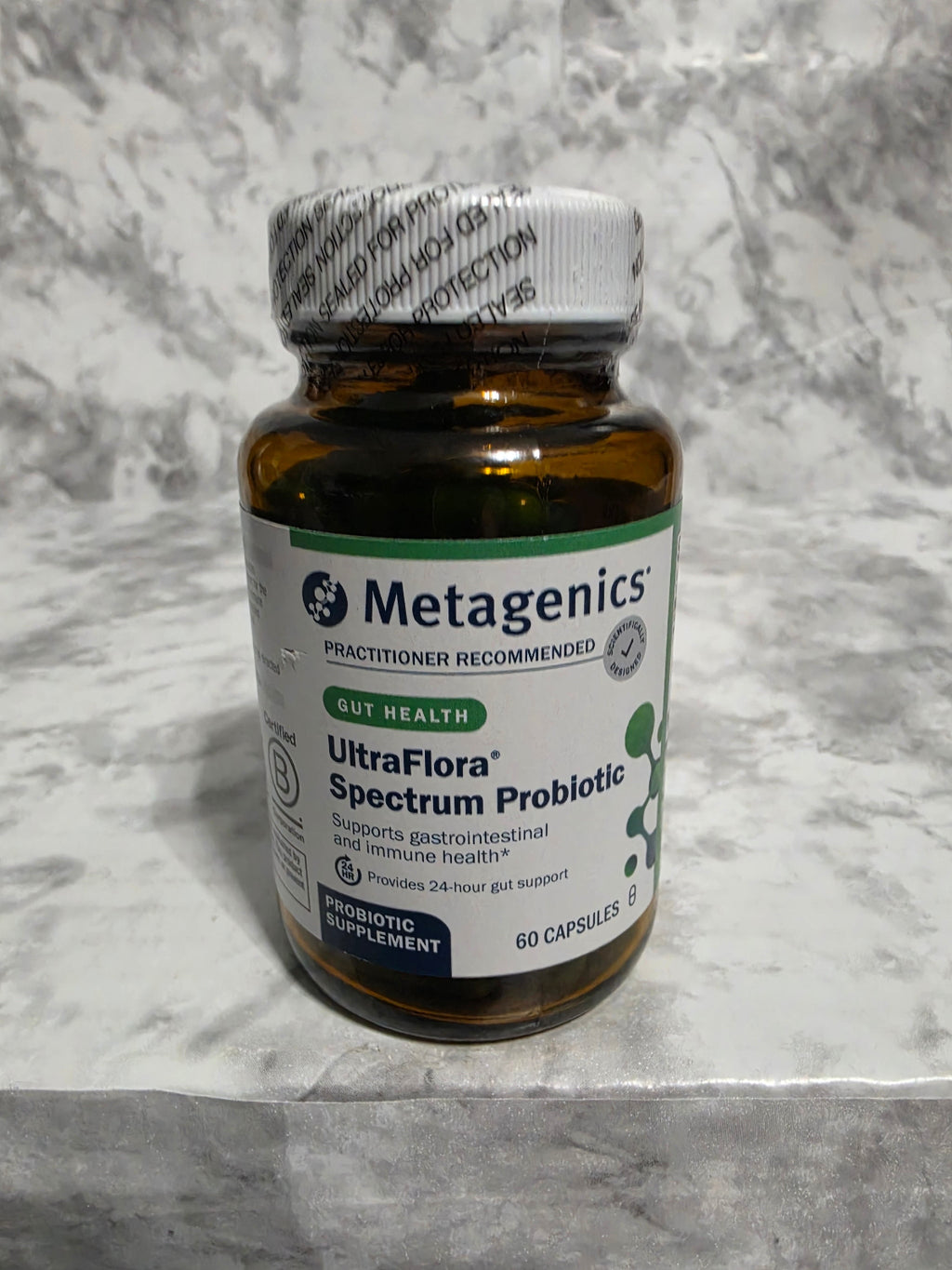 Metagenics UltraFlora Spectrum Probiotic bottle on a marble surface