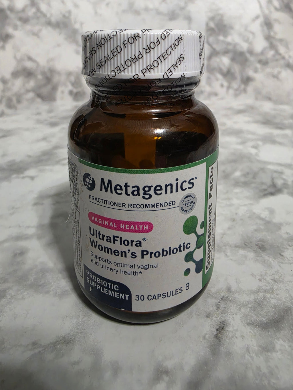 Bottle of Metagenics UltraFlora Women's Probiotic on a marble surface