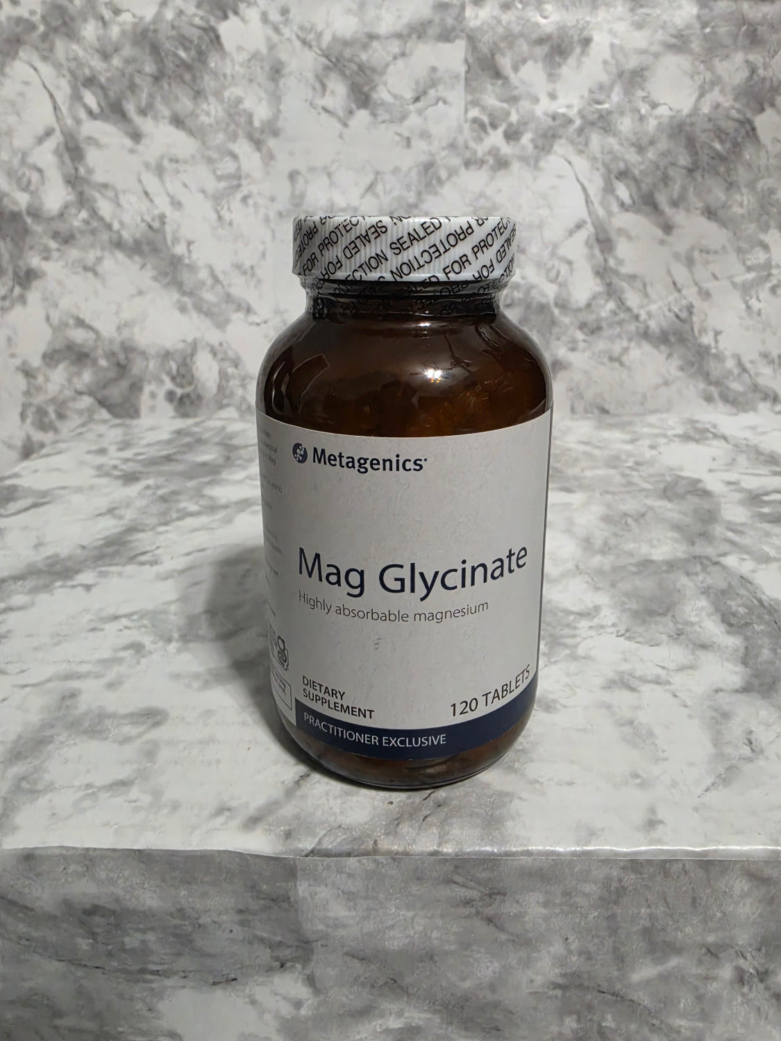 Bottle of Metagenics Mag Glycinate on a marble surface