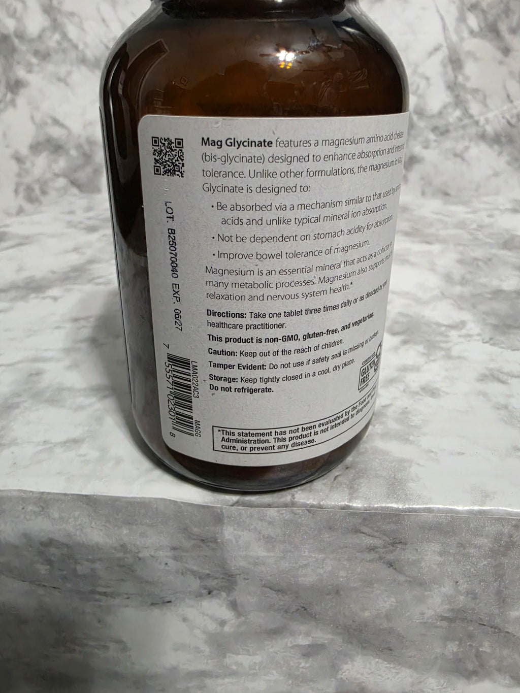 Brown bottle with label on a marble surface