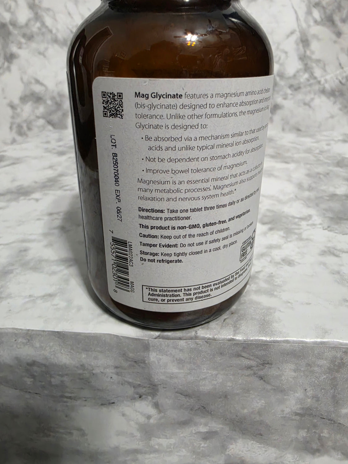 Brown bottle with label on a marble surface