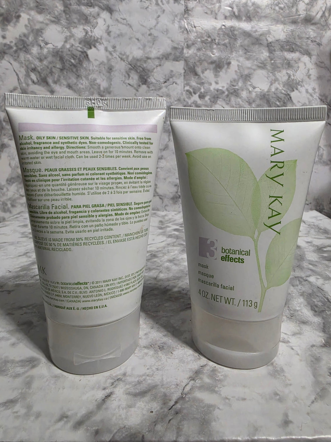 Two Mary Kay skincare products on a marble surface