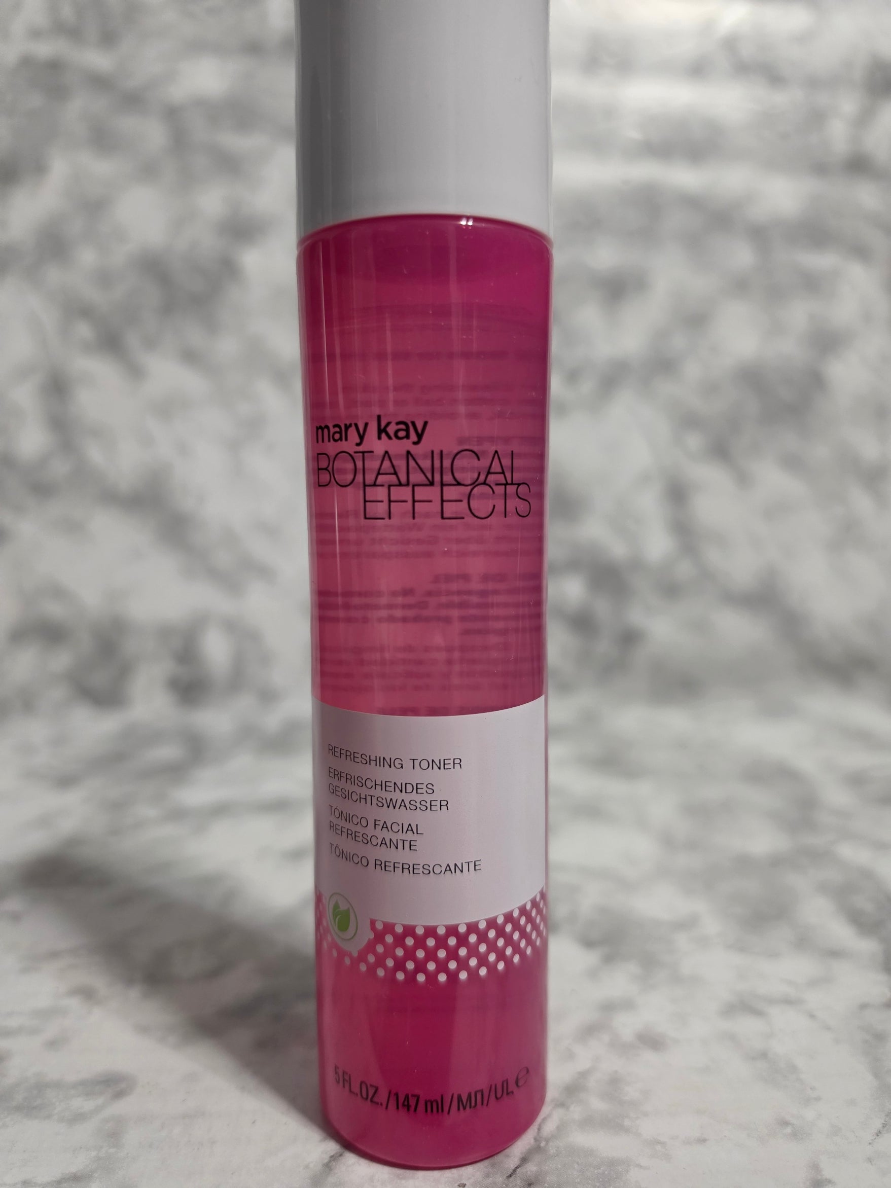 L'Oreal Paris Botanical Effects toner bottle on a textured gray background