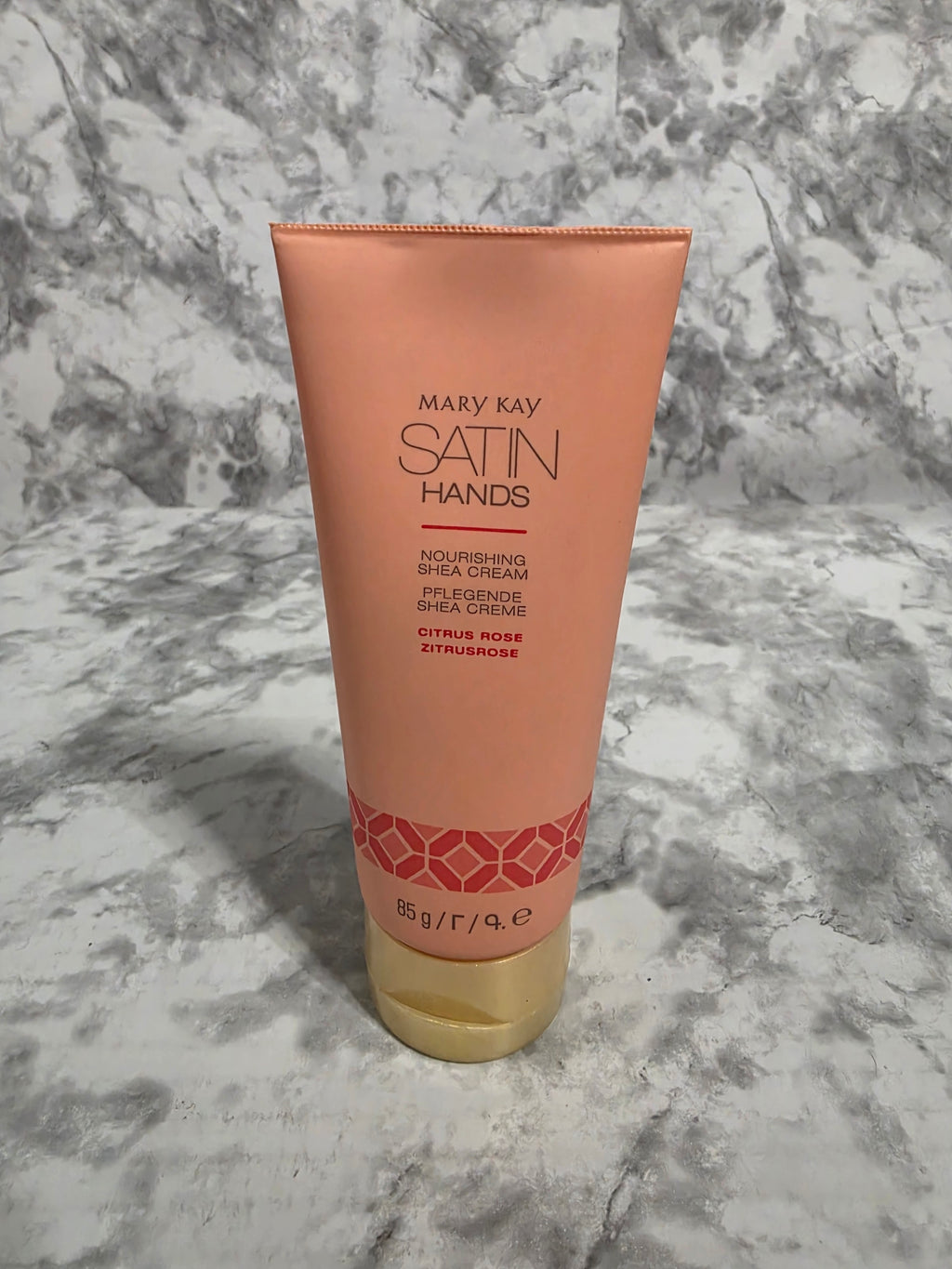 Mary Kay Satin Hands hand cream tube on a marble surface