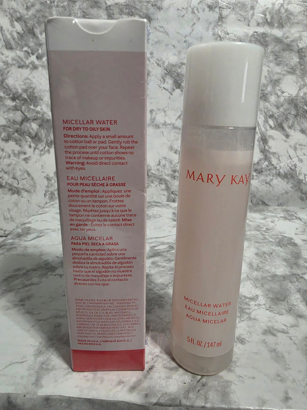 Two Mary Kay skincare products on a marble surface