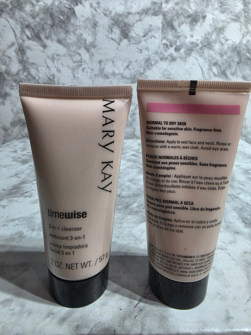 Two Mary Kay skincare products on a marble surface