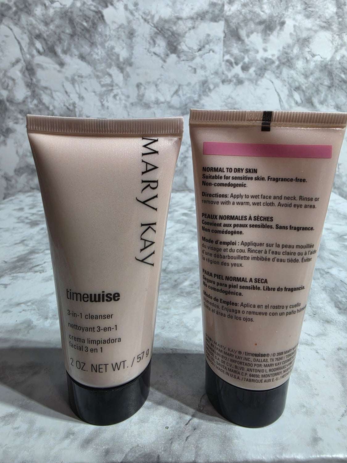 Two Mary Kay skincare products on a marble surface