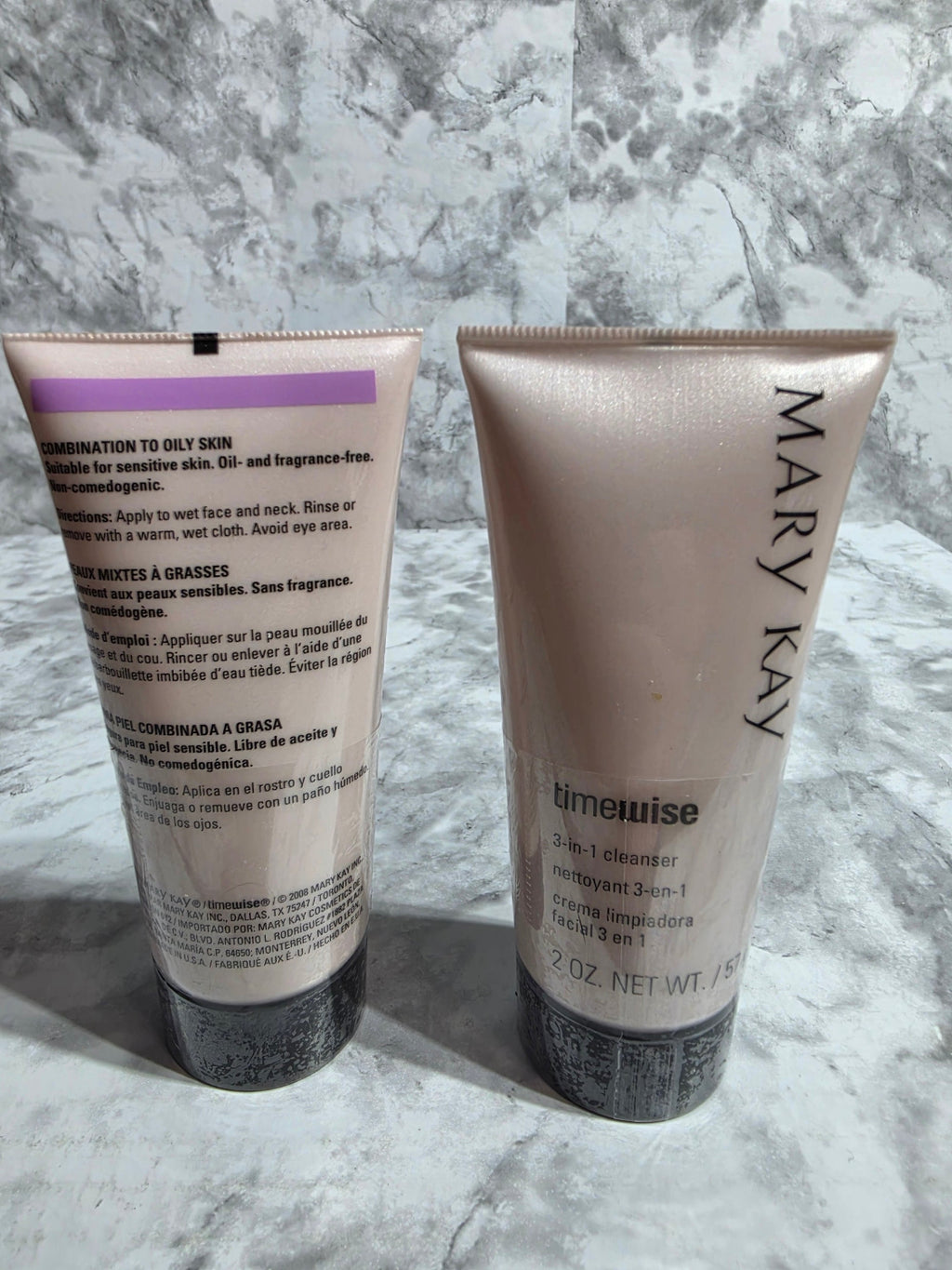 Two skincare products from Mary Kay on a marble surface