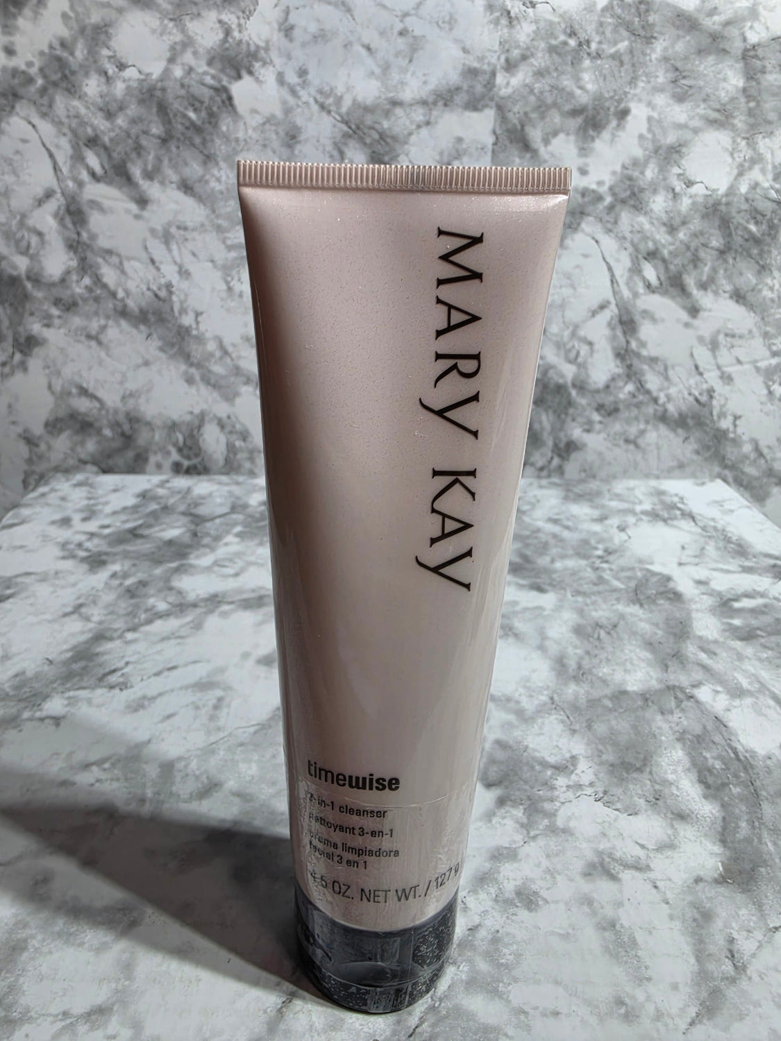 Mary Kay skincare product tube on a marble surface