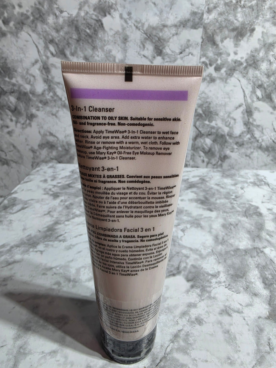 Tube of skincare product on a marble surface