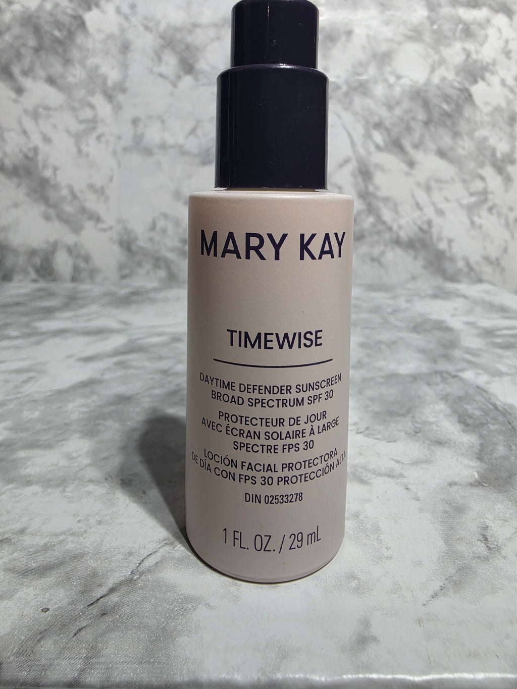 Mary Kay TimeWise bottle on a marble surface