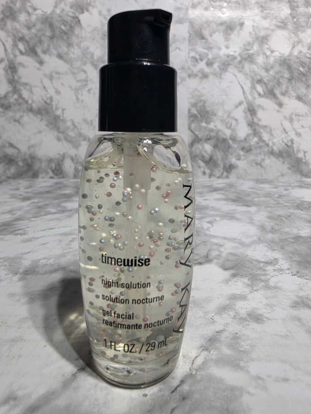 Bottle of Mary Kay TimeWise gel facial on a marble surface