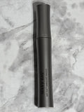 Black handheld device with 'MARY KAY' branding on a marble surface