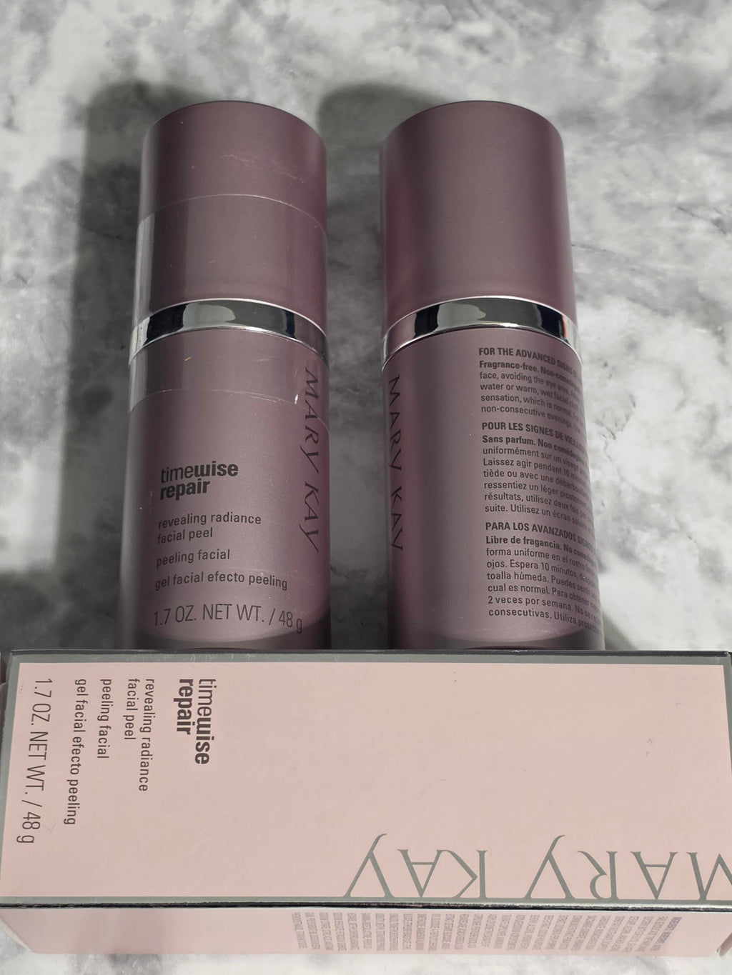 Two Mary Kay Limewise Repair skincare products on a textured surface.