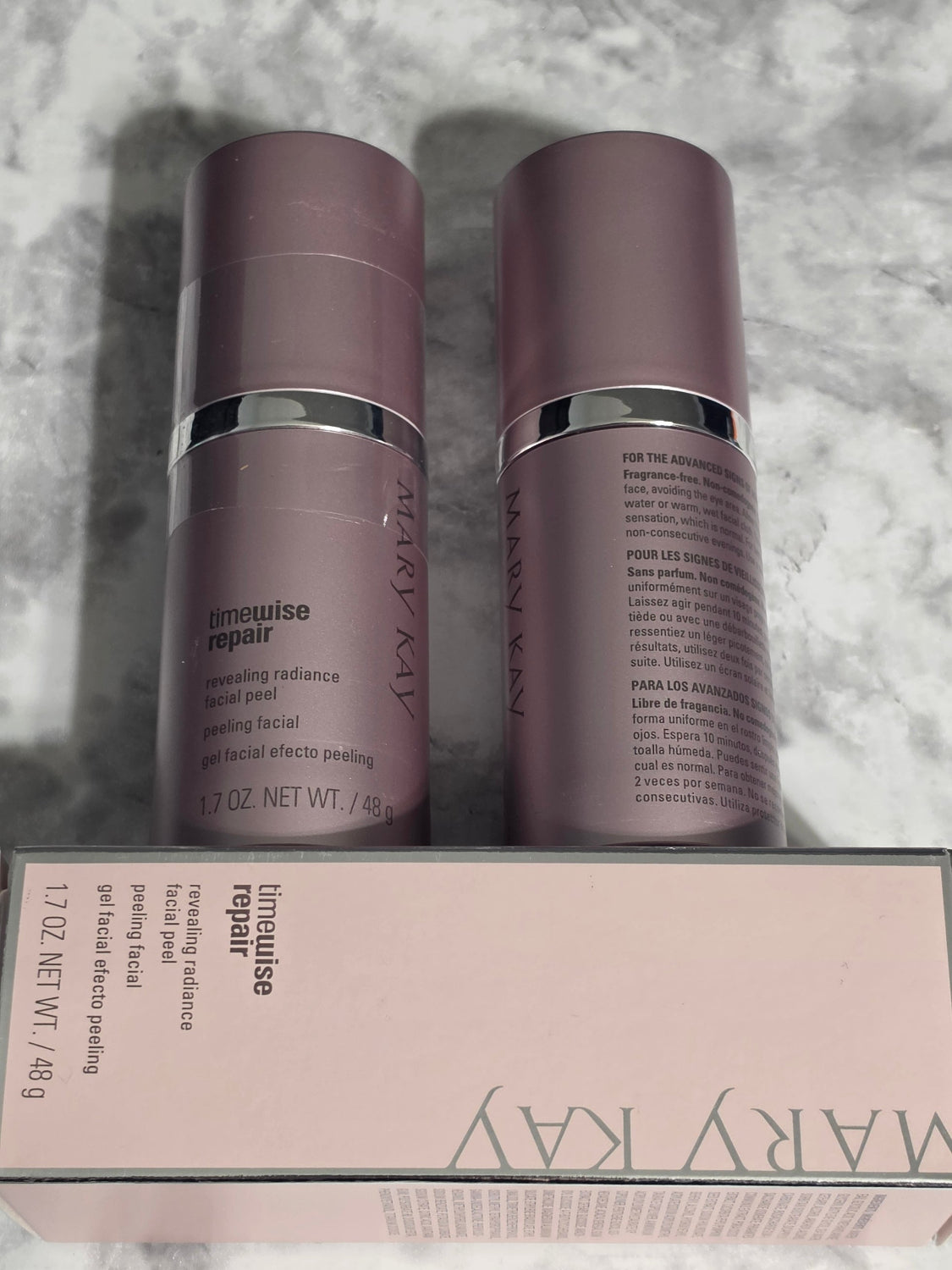 Two Mary Kay Limewise Repair skincare products on a textured surface.