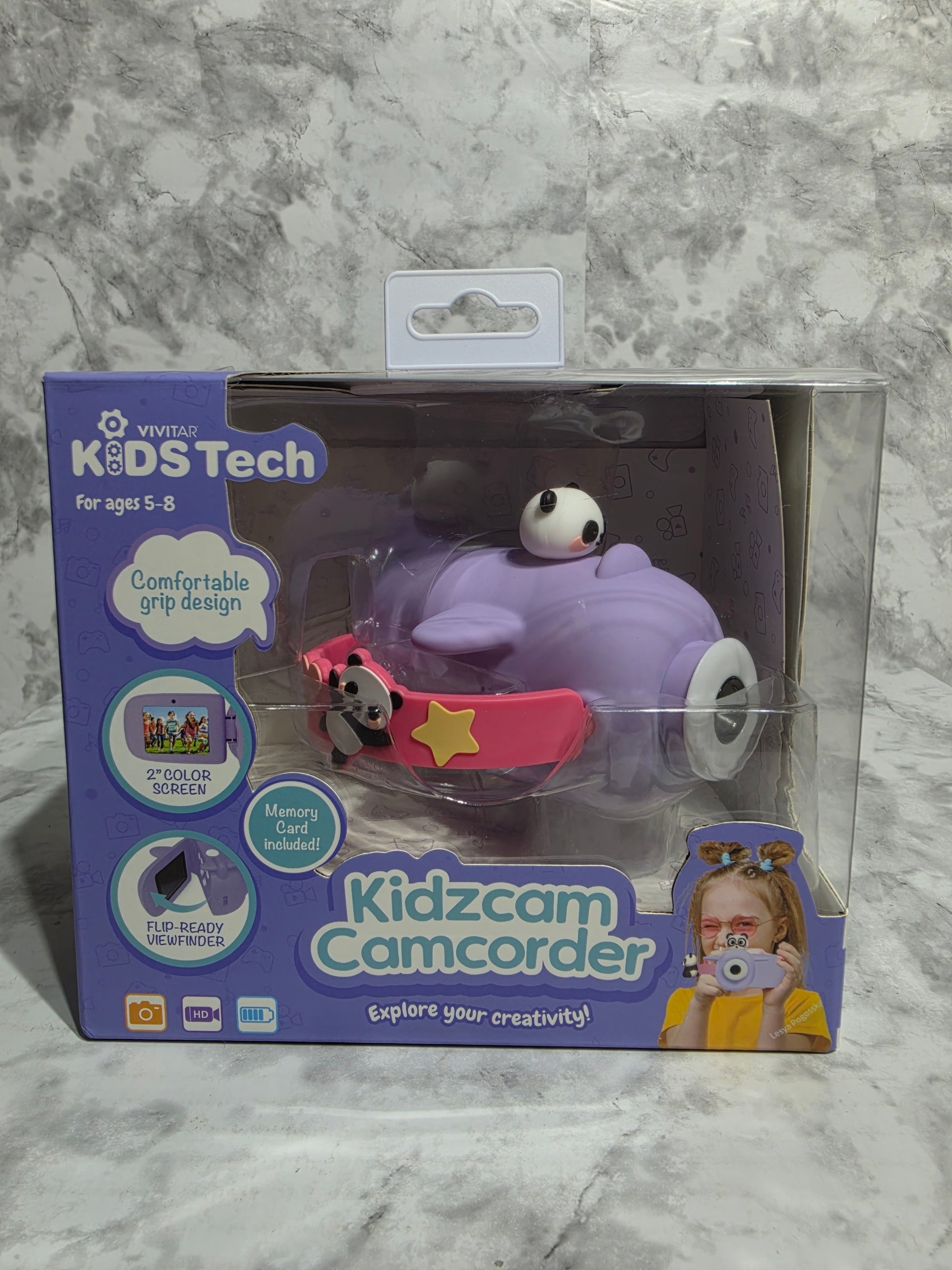 Purple toy with a camera on a gray marble surface
