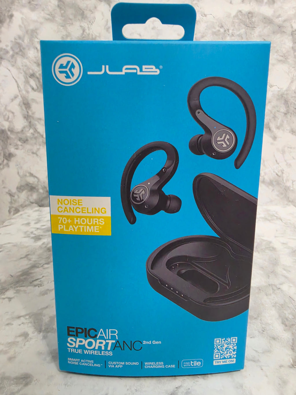 JLab Epic Air Sport ANC wireless earbuds packaging on a marble surface
