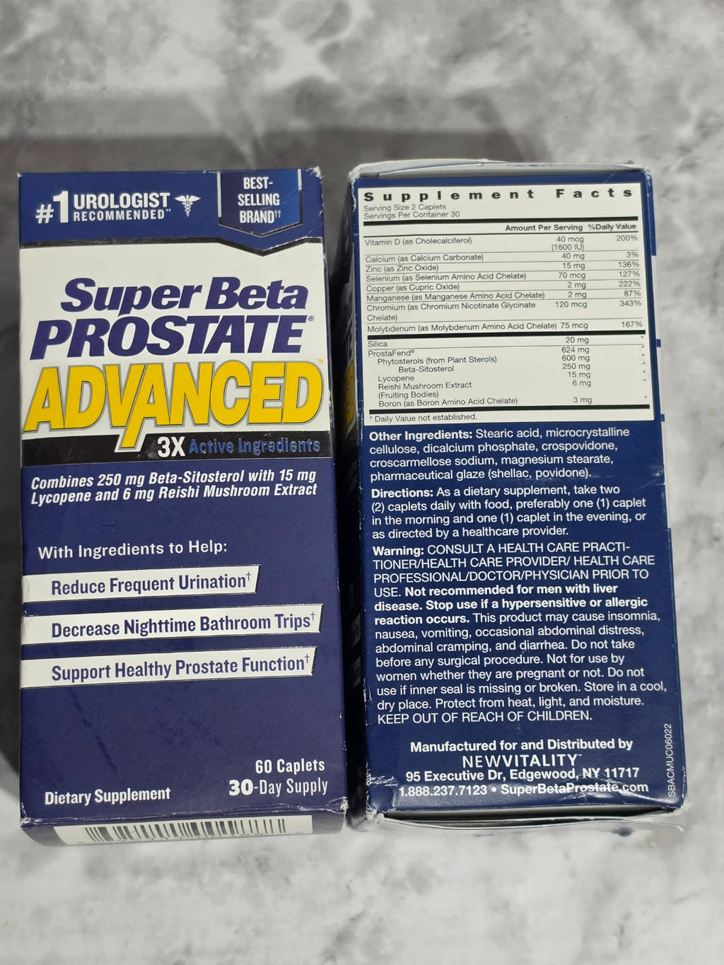 Two boxes of Super Beta Prostate Advanced 3X dietary supplement on a gray surface.