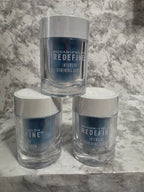 Three bottles of Ralph Lauren Redefine Intensive Renewing Serum on a marble surface.