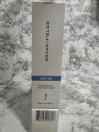 Rodan + Fields product packaging on a marble surface