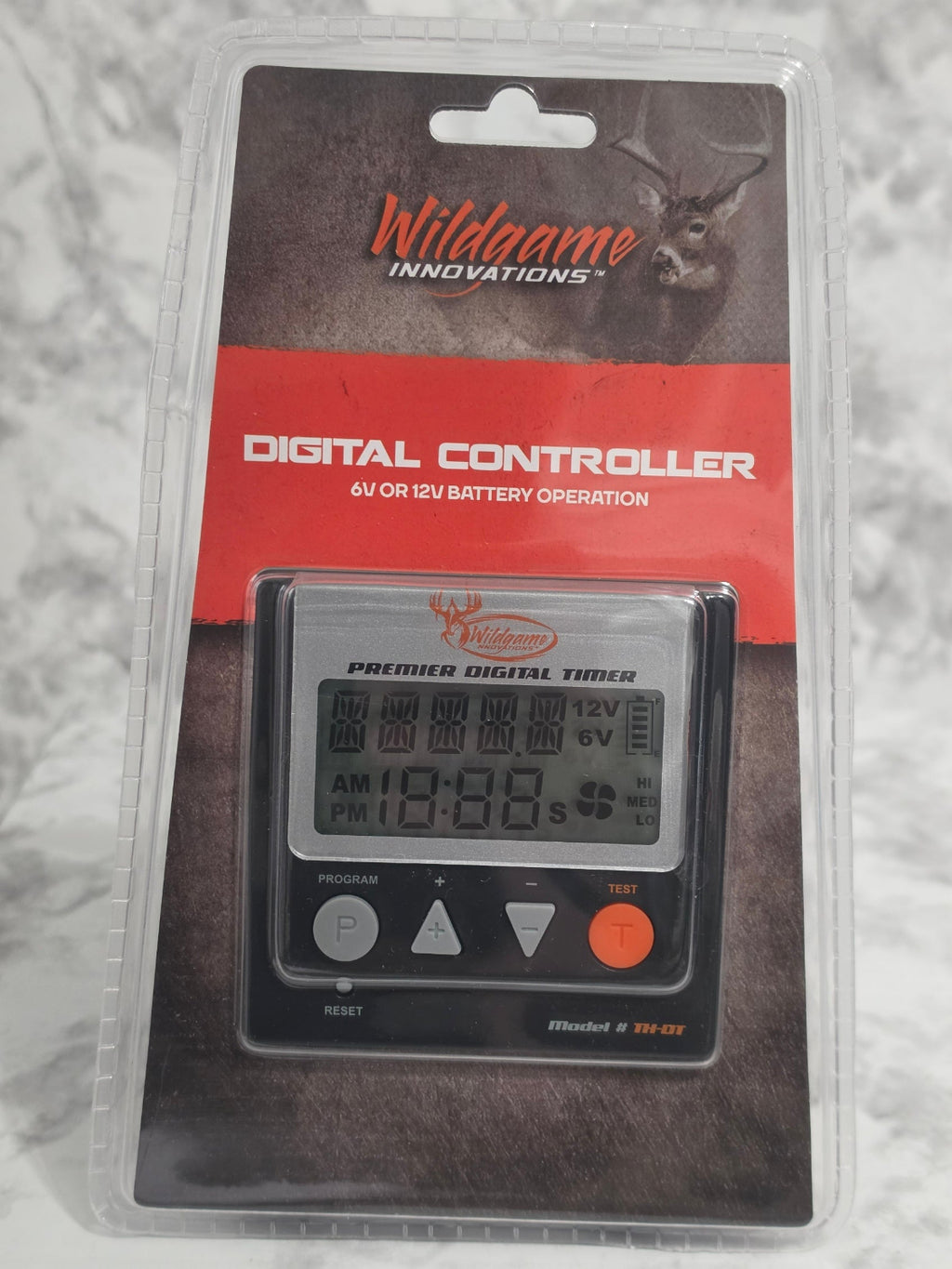 Digital controller in packaging with visible branding on a textured surface