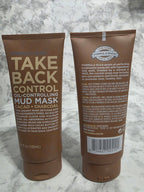 Two brown tubes of 'Take Back Control' mud mask on a marble surface