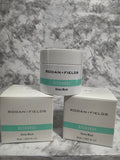 Two containers and their packaging of Rodan + Fields Recharge Deep Mask on a marble surface.