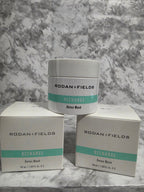 Two containers and their packaging of Rodan + Fields Recharge Deep Mask on a marble surface.