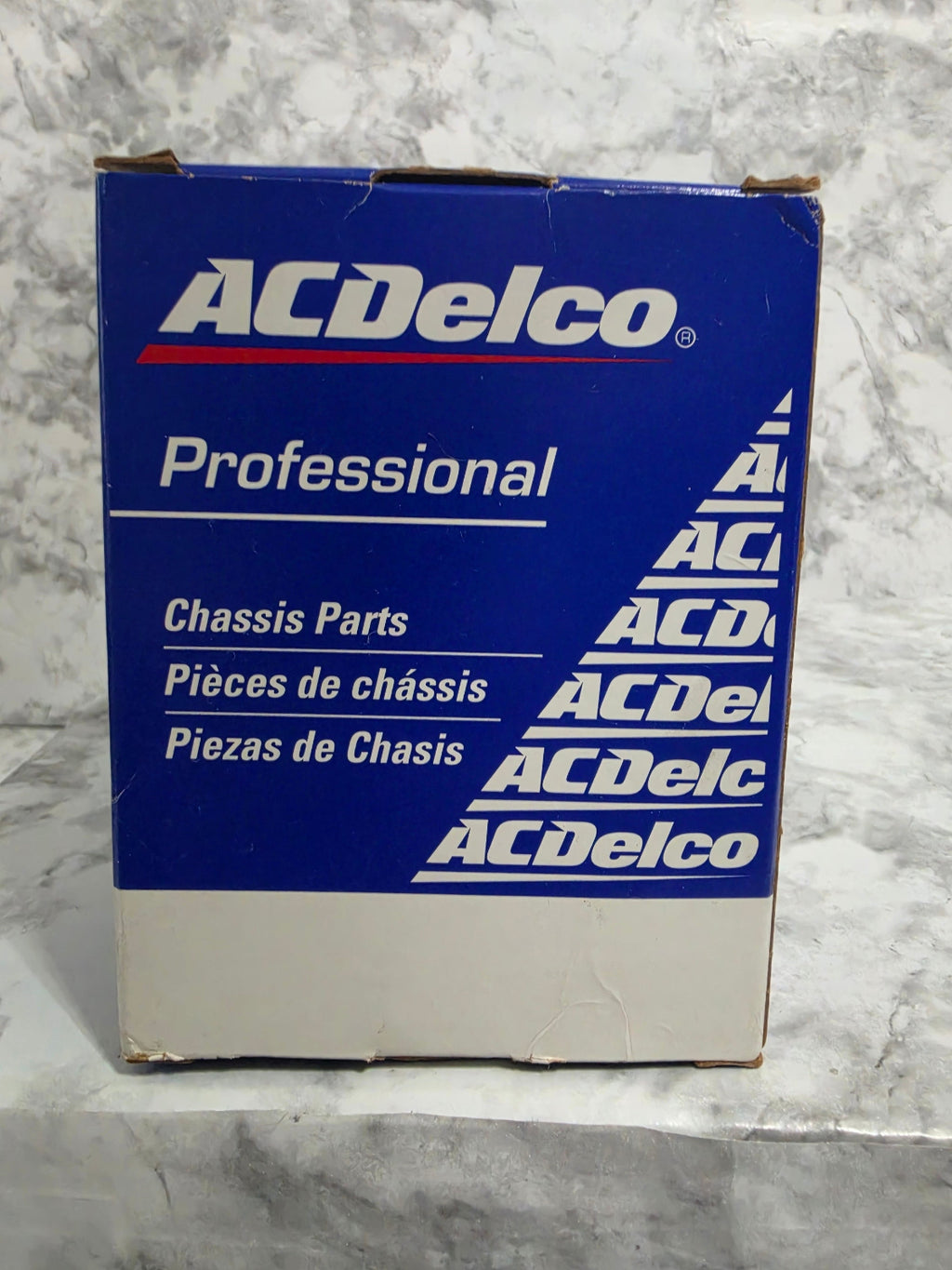 ACDelco professional chassis parts box on a gray surface