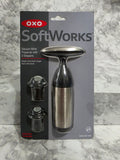 OXO SoftWorks Vacuum Wine Preserver 3-Piece Set — stainless steel pump with 2 BPA-free stoppers in original retail blister packaging, photographed on marble workspace at More4less Outlet Burlington KY