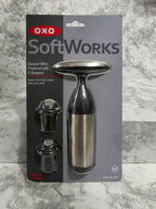 OXO SoftWorks Vacuum Wine Preserver 3-Piece Set — stainless steel pump with 2 BPA-free stoppers in original retail blister packaging, photographed on marble workspace at More4less Outlet Burlington KY